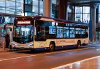 airport shuttle bus waiting outside a terminal