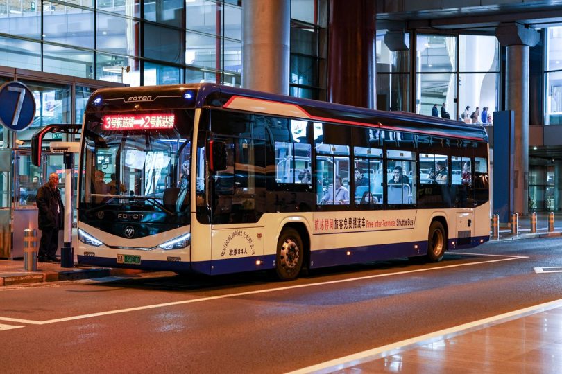 airport shuttle bus waiting outside a terminal
