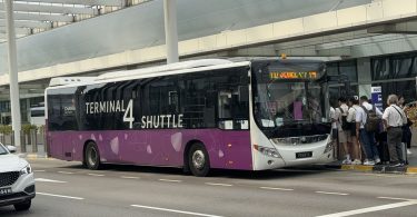 airport shuttle bus outside a terminal
