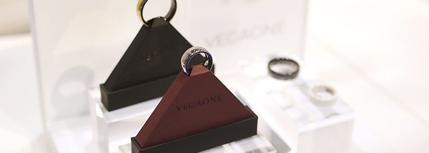 A smart ring worn on a finger, close up