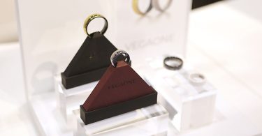 A smart ring worn on a finger, close up