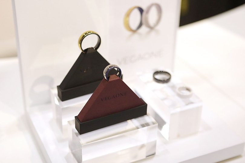 A smart ring worn on a finger, close up